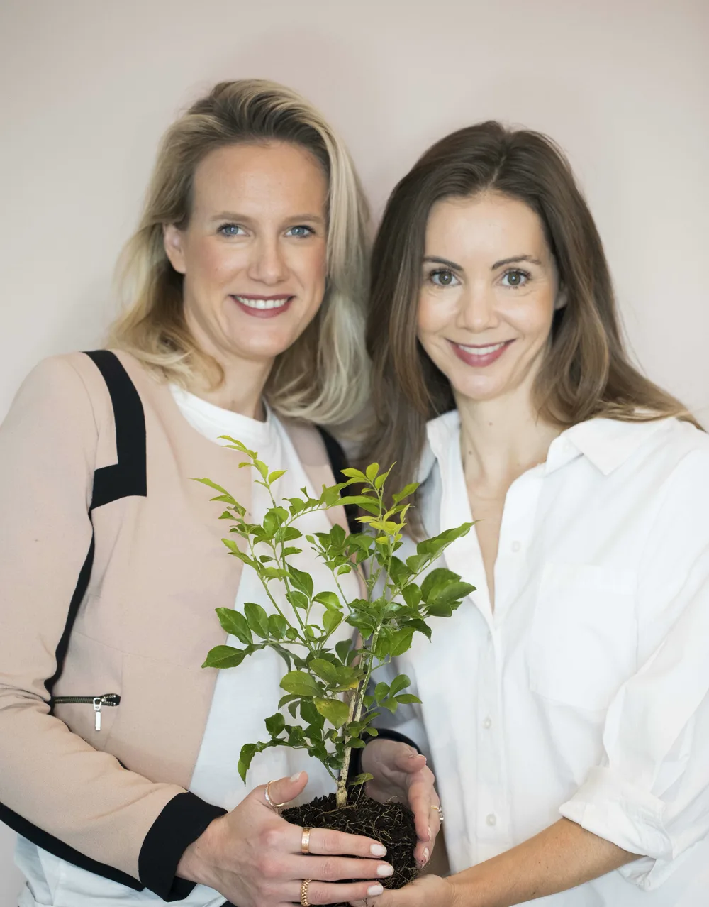 Co-founders Marlen Farley and Verity Byrne holding a sapling